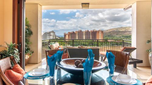 a balcony with a table and chairs with a view at Ko Olina Beach Villas O1111 in Kapolei