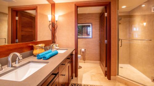 a bathroom with a sink and a shower at Ko Olina Beach Villas O1111 in Kapolei