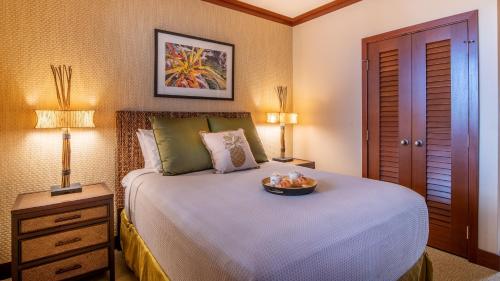 a bedroom with a bed with a bowl on it at Ko Olina Beach Villas O1111 in Kapolei