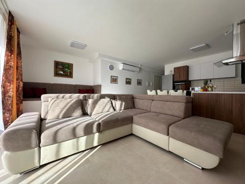 Il comprend un salon avec un canapé et une cuisine. dans l'établissement New, airy and spacious apartment in Mellieha, à Mellieħa