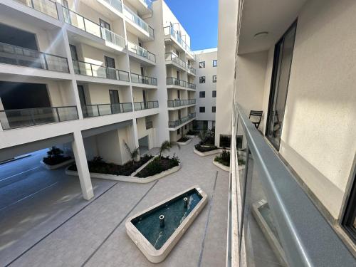 an apartment building with a bath tub in the courtyard at New, airy and spacious apartment in Mellieha in Mellieħa