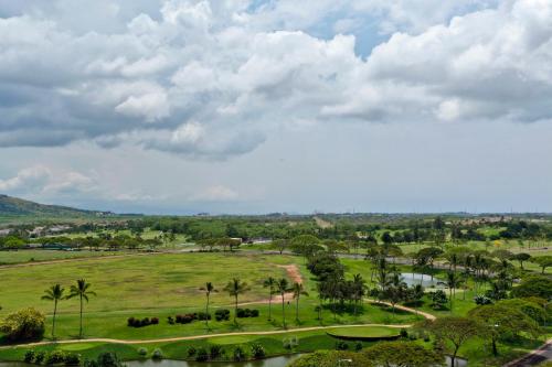 a view of a park with palm trees and a river at Ko Olina Beach Villas O1121 in Kapolei