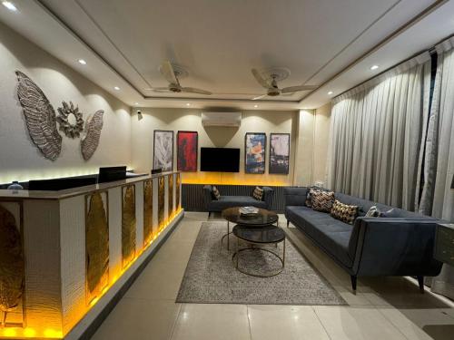 a living room with a couch and a table at Shelton Boulevard Hotel Lahore in Lahore