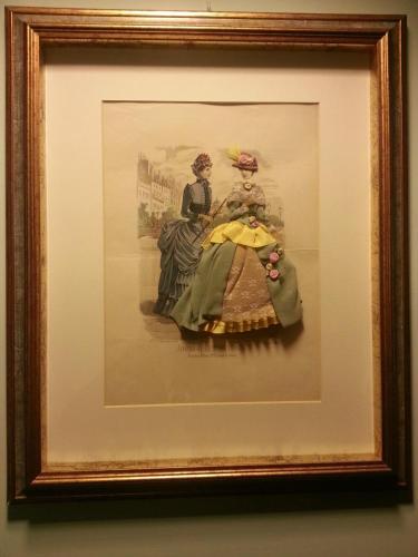 a framed picture of two people in victorian clothes at Hotel Berchielli in Florence