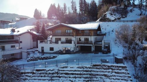 a house on a snow covered hill with snow at Haus Schlatti in Altenmarkt im Pongau