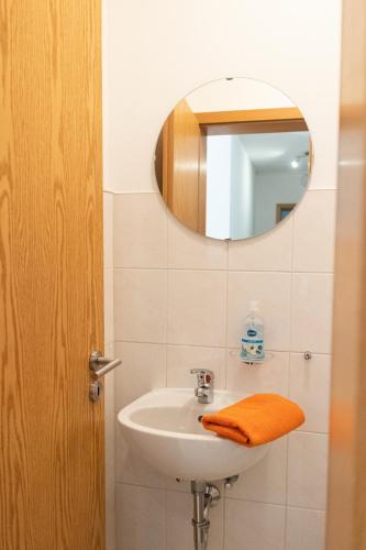a bathroom with a sink and a mirror at Apartment Ohragrund in Oberhof