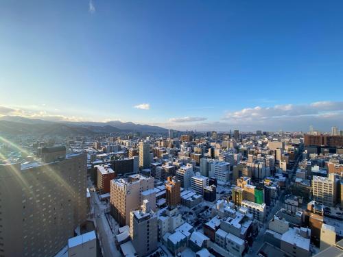 an aerial view of a city with buildings at Nakajima Park stay AMS tower 32F Panoramic view of Sapporo city in Sapporo