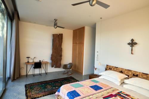 a bedroom with a bed and a table and a desk at Elegant modern Villa in olive grove in Surano