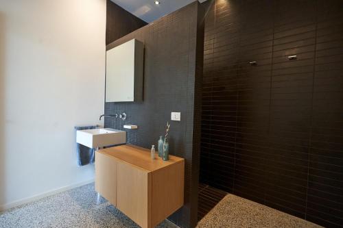 a bathroom with a sink and a mirror at Elegant modern Villa in olive grove in Surano