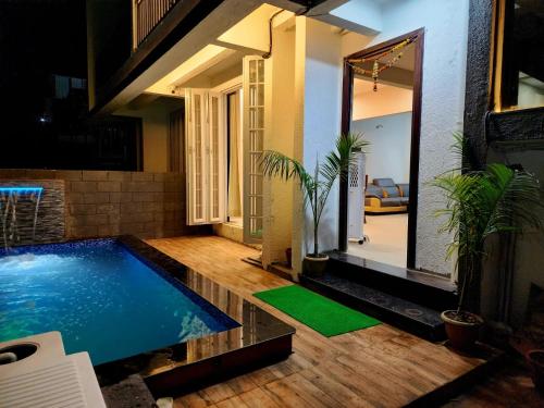 a swimming pool in the middle of a house at Twilight Villa ll Swimming Pool ll AC ll BBQ ll 2BHK in Lonavala