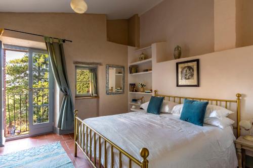 a bedroom with a large bed with blue pillows at Casa Ezio Marchi - Tre spaziose suite in Bettolle