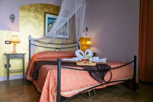 a bedroom with a large bed with a canopy at Villa da Sogno con piscina privata in Avola