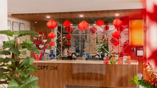 a restaurant with red paper lanterns hanging above a counter at Gold Central Hotel by Haviland in Da Nang