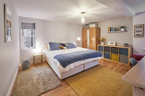 a bedroom with a bed with blue pillows at Host & Stay - The Willows in Teversall