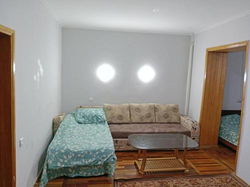 sala de estar con sofá y mesa en markaz 6 Uy-122A Honadon-9, en Tashkent