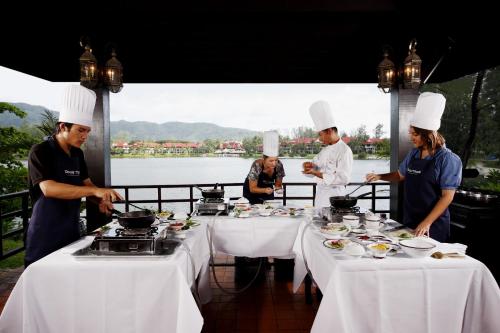 a group of chefs preparing food on a table at Dusit Thani Laguna Phuket in Bang Tao Beach