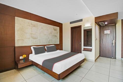 a bedroom with a large bed in a room at Venkys stay inn in Udupi