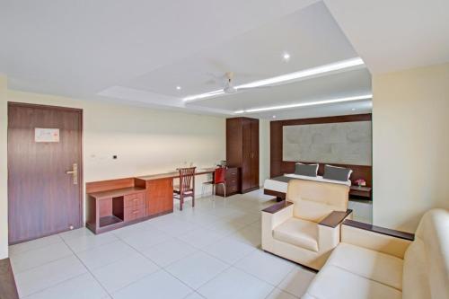 a living room with a couch and a table at Venkys stay inn in Udupi