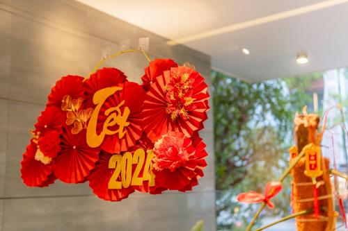 a bouquet of red flowers hanging in a room at SHI HOUSE by Haviland in Da Nang
