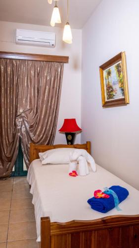 a bedroom with a bed with towels on it at Marathi Apartments in Marathi