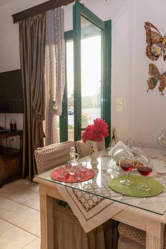 a kitchen with a table with glasses of wine at Marathi Apartments in Marathi