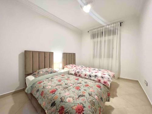 a bedroom with two beds and a window at Tanger lovely apart only family in Tangier