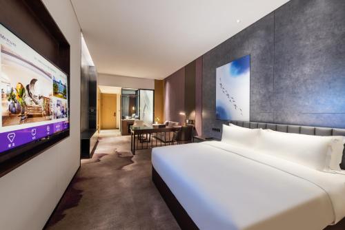 Postel nebo postele na pokoji v ubytování Mercure Shenzhen Longgang