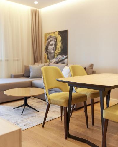 a living room with a table and chairs and a couch at Vip Casa Club Zlatibor in Zlatibor