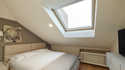 a bedroom with a white bed and a window at Vip Casa Club Zlatibor in Zlatibor