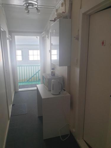 a room with a microwave on a counter with a window at Holiday Rooms in Gol