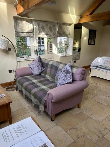 a living room with a couch and a bed at The Potting Shed in Warwick