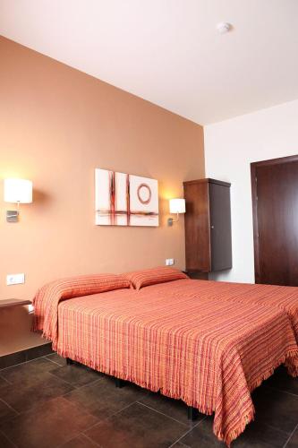 Ένα ή περισσότερα κρεβάτια σε δωμάτιο στο Hostal Real