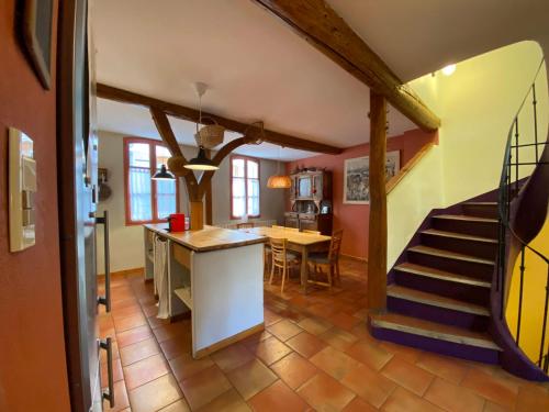 a kitchen and dining room with a staircase in a house at Maison familiale centre Avignon in Avignon