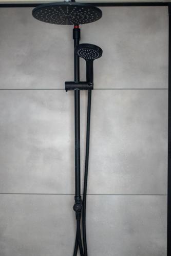 a black umbrella on a stand on a floor at Ibiza Style Holiday chalet in Susteren