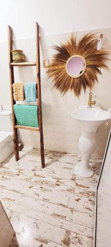 a bathroom with a sink and a mirror at Mint hause in Nungwi