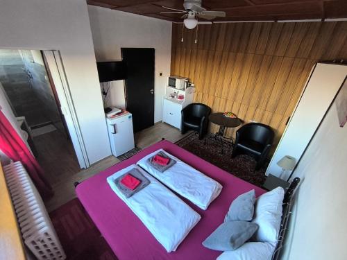 Habitación con cama, mesa y sillas. en Penzion U Ježů - Ubytování en Pasohlávky