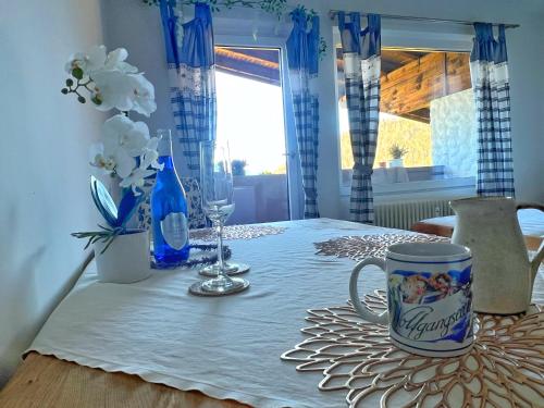 a table with a white table cloth and a cup on it at Apartment Sunset am Wolfgangsee in Strobl