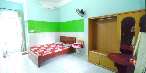 a bedroom with a bed and a sink in it at Hostel Loc Quyen in Da Nang