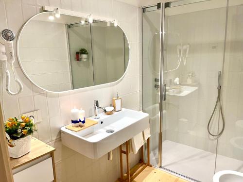 La salle de bains est pourvue d'un lavabo et d'une douche. dans l'établissement Stella Delle Alpi by Holiday World, à Pinzolo