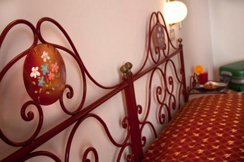 a bedroom with a bed with a red metal frame at My Home Hotel in Bellaria-Igea Marina