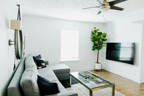 a living room with a couch and a table at The Vinyl at Music Row - Garden Suite in Nashville