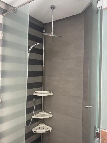 a shower with three shelves in a bathroom at Very beautiful apartment with see view 5th in Casablanca