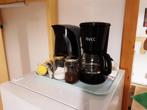 a coffee maker sitting on top of a refrigerator at Parselia in Therma