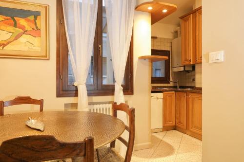 a kitchen with a table and a dining room at Saint Charles Apartment in Bologna