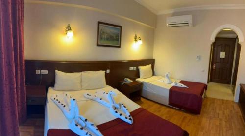 Кровать или кровати в номере ASTORIA PARK HOTEL & Spa ALL INCLUSIVE CONCEPT