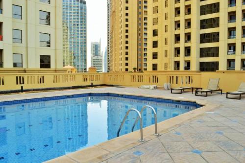 a swimming pool on the roof of a building at Vacation Home In Best Part of Dubai in Dubai