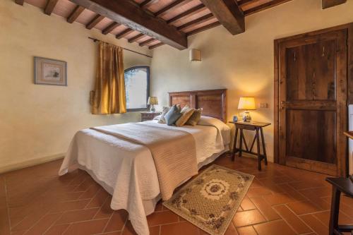 a bedroom with a bed and a window and a table at Residence Il Gavillaccio in Figline Valdarno
