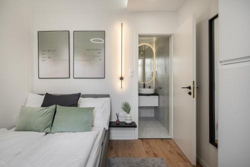 een witte slaapkamer met een bed en een badkamer bij K27- Boutique Apartments, Best Location, by BQA in Boedapest