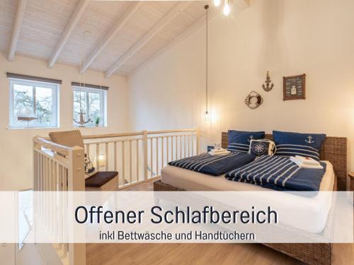 a bedroom with two beds with blue pillows at RamosHansenHof Fewo Fördebrise mit Sauna in Steinberg