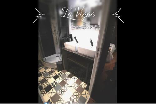a bathroom with a sink and a mirror with the words i dunno at La Roche Blanche, maison de bourg pleine de charme in La Roche-Blanche